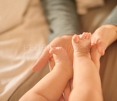 Buy stock photo Hands, baby feet and home in bedroom, newborn and family for love, care and nurture. Bonding, support and childhood in person, infant and parent with tiny, toddler and  connection, skin and develop