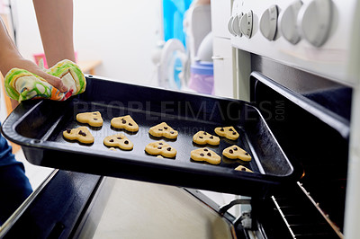 Buy stock photo Woman, bake and heart cookies from oven in kitchen as chef with fresh or homemade dessert on mothers day with love as surprise. Baker, person and hands with biscuits as snack for bakery as culinary