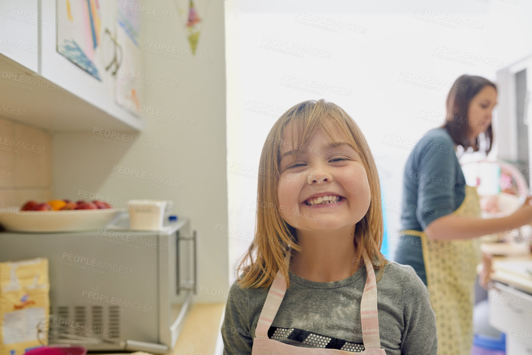 Buy stock photo Portrait of a little girl standing in the kitchen with her face covered in flour