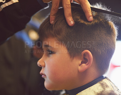 Buy stock photo Closeup shot of a young boy getting a haircut at a barber shop