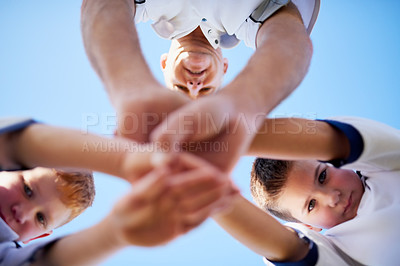 Buy stock photo Low angle shot of two young soccerplayers and their coach in a huddle