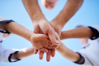 Buy stock photo Low angle shot of two unidentifiable young soccerplayers and their coach in a huddle