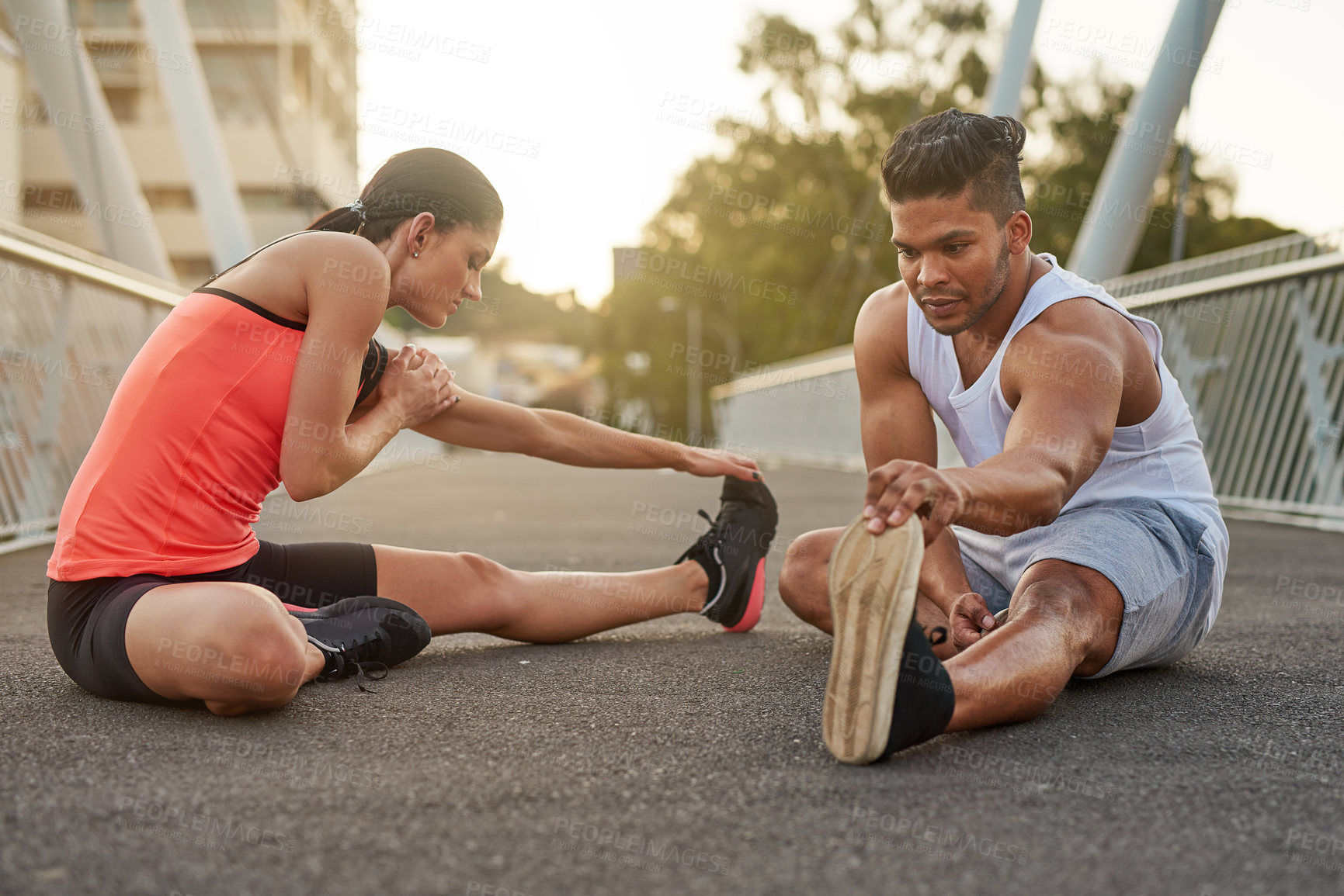 Buy stock photo Fitness, exercise and couple stretch on bridge for health, wellness or warmup for run. Man, woman and training on road for cardio, preparation and workout together in city for marathon, jog or sprint