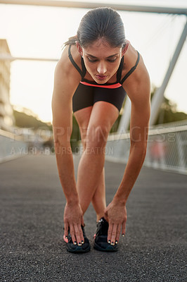 Buy stock photo Fitness, woman and stretch legs on bridge for sports training or workout as athlete for health or wellness. Young, active female and warm up with sneakers for marathon with exercise or cardio in city