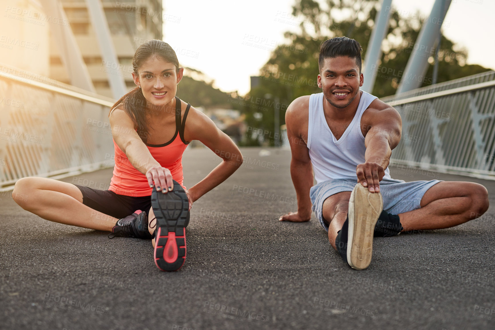 Buy stock photo Fitness, portrait and couple stretch on bridge for health, wellness or warmup for run. Man, woman and training on road for cardio, preparation and workout together in city for marathon, jog or sprint