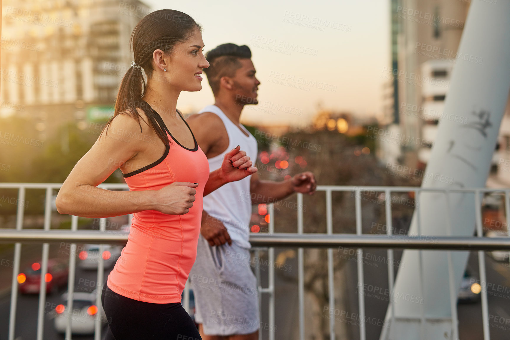 Buy stock photo Couple, fitness and smile running outdoor for exercise, workout or cardio routine together on bridge. Happy, man and woman training or fast walking on road for strength, wellness and healthy bonding
