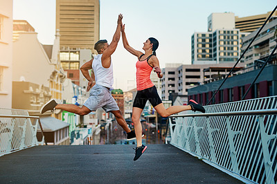Buy stock photo High five, runner or happy people jump for fitness training, exercise or workout success on outdoor bridge. City, excited or sports athletes with friends or teamwork for running on urban street road