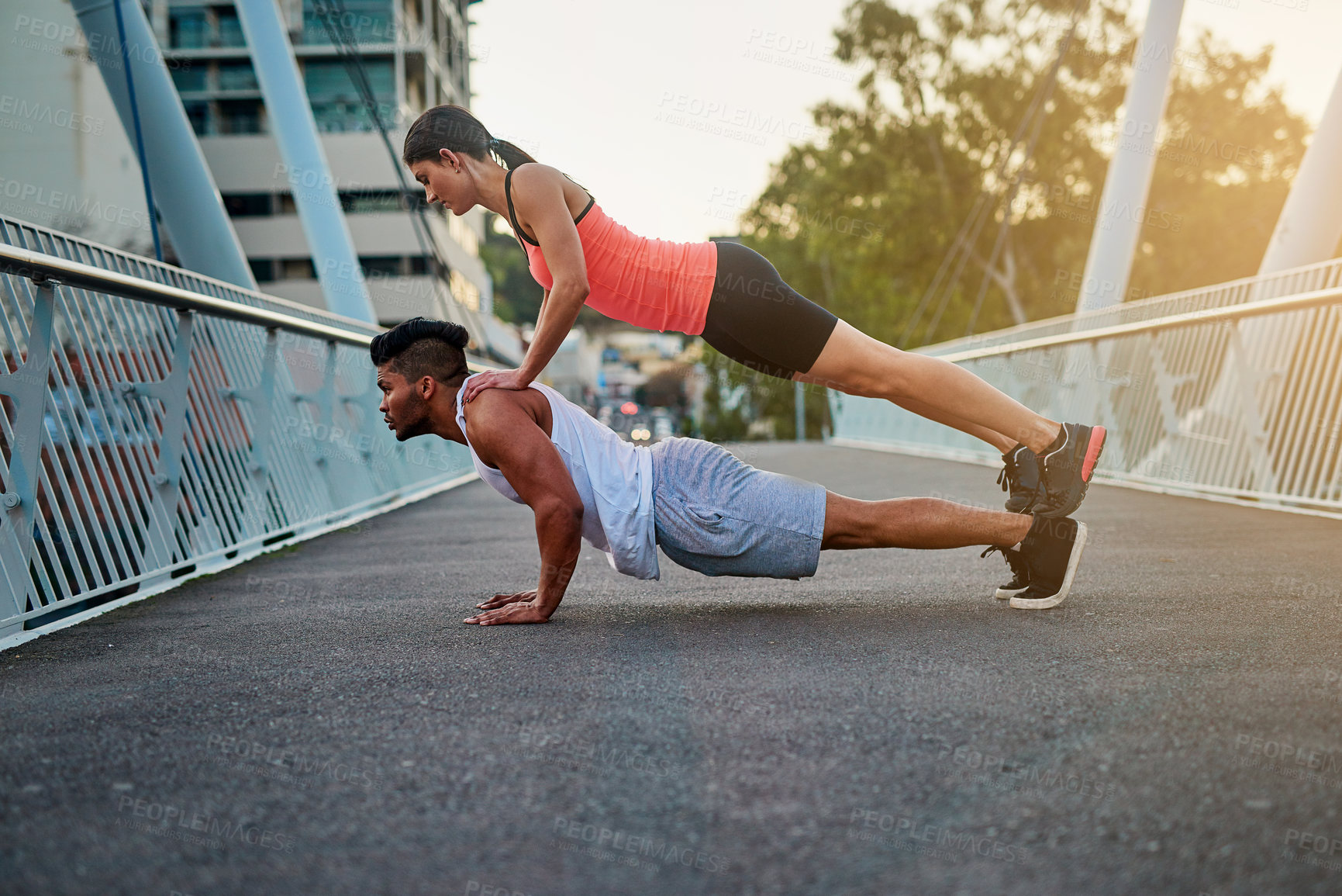 Buy stock photo Couple, bridge and balance on back for fitness or daily exercise for training, pushup and workout partner for health. Man, girl and together outdoor for bonding for wellness or wellbeing and cardio.