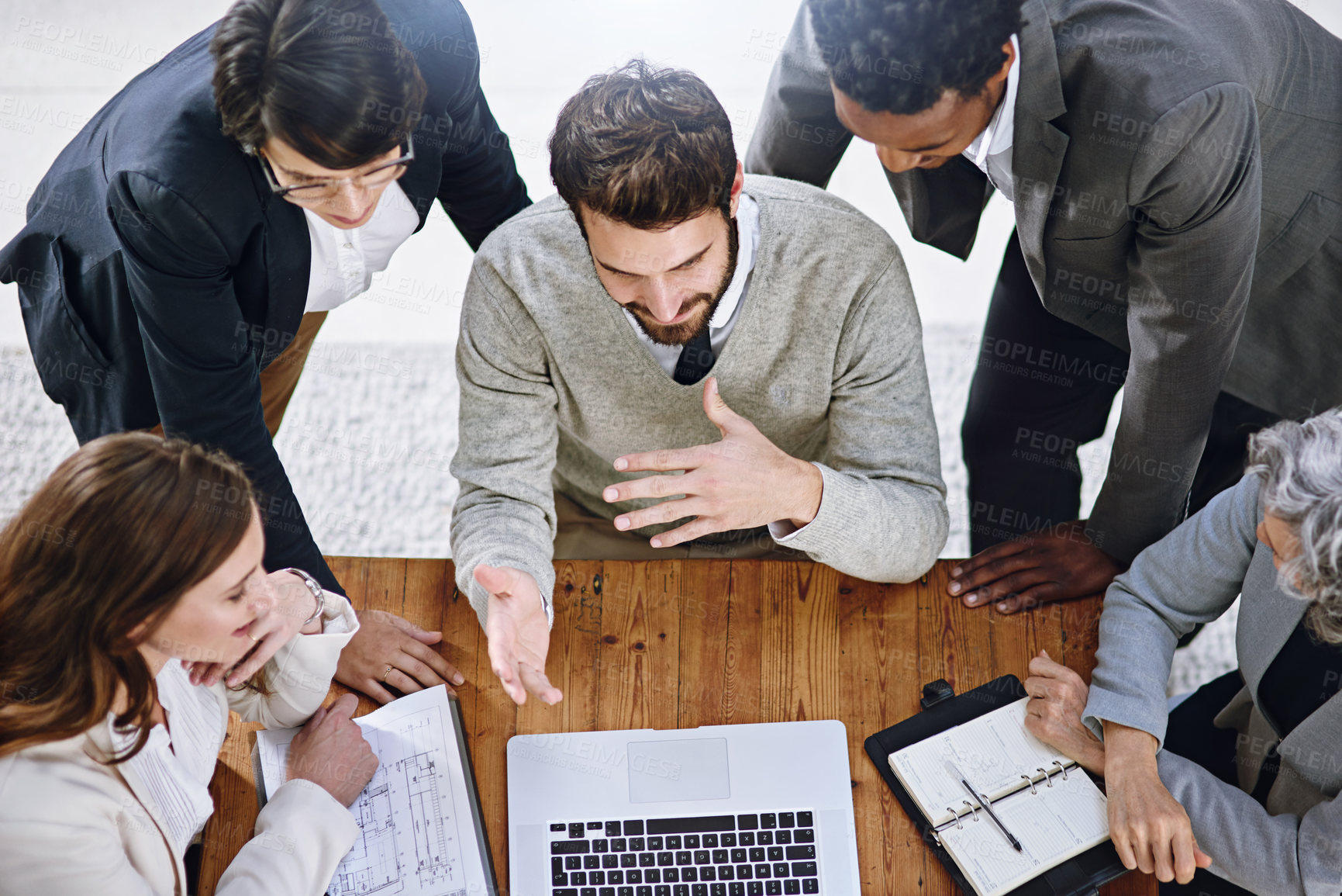 Buy stock photo High angle shot of a group of businesspeople having a meeting in an office