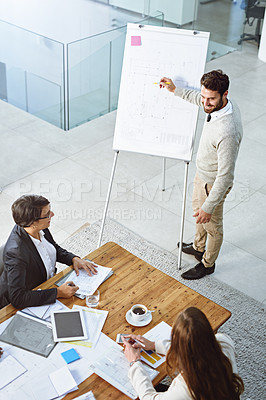 Buy stock photo High angle shot of an architect giving a presentation to his colleagues in an office