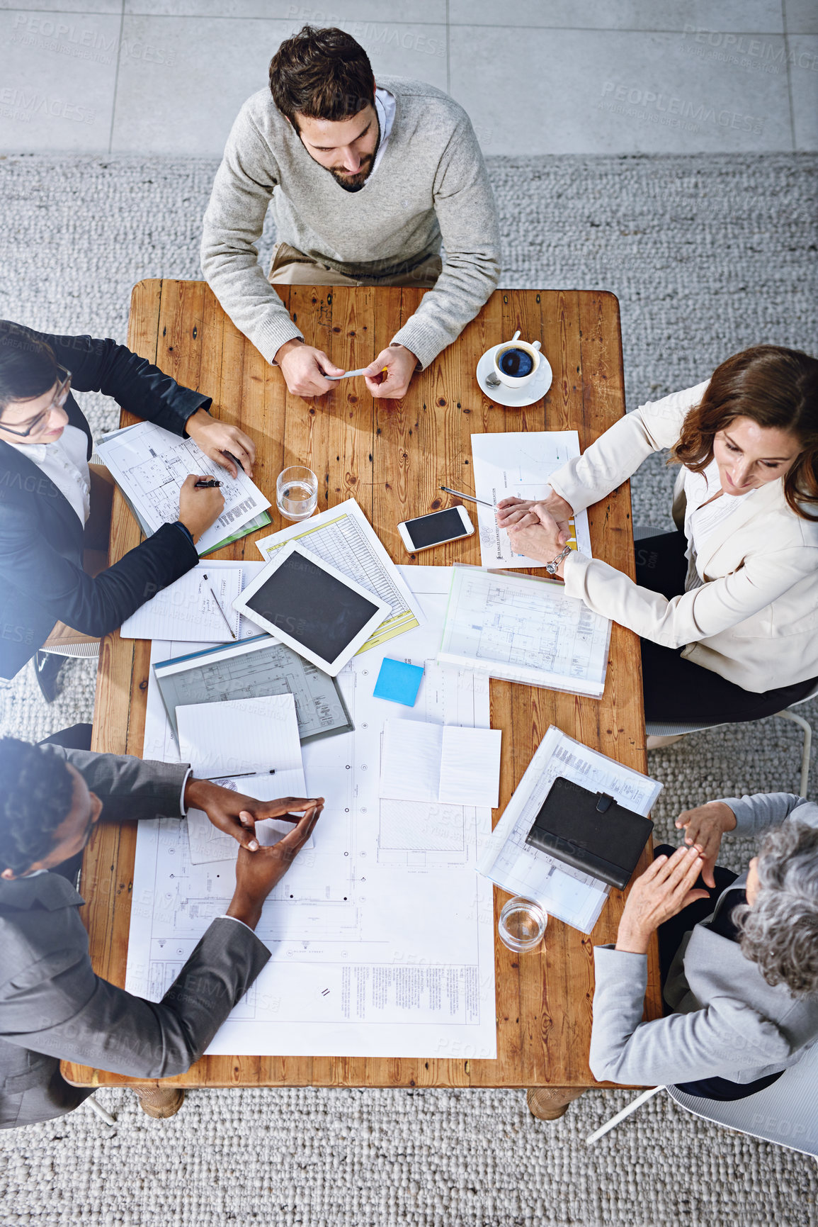 Buy stock photo High angle shot of a group of businesspeople having a meeting in an office