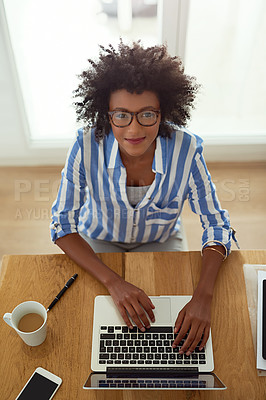 Buy stock photo Portrait, woman and top view with laptop, working and home with coffee, remote work and smile. African employee, typing and glasses for computer, online and electronic or freelancer, pc and digital