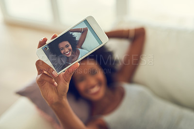 Buy stock photo Cropped shot of a young woman taking a photo of herself