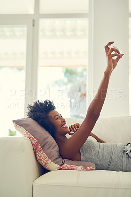 Buy stock photo Home, selfie and black woman relax on sofa and post on social media or web with happiness. Virtual, chat and girl on video call with smile on couch in living room of apartment or profile picture