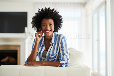 Buy stock photo Portrait, black woman and couch in home for relax, calm or living room on break. Face, smile or rest on sofa in lounge for female person with afro, furniture or peace on weekend for wellness in house