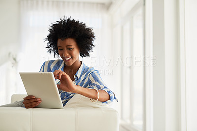 Buy stock photo Black woman, home and happy sofa with tablet for social media post and entertainment. Female person, living room and couch on internet for streaming service or website for news update or funny videos