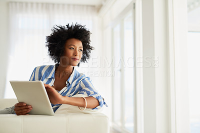 Buy stock photo Black woman, home and thinking with tablet on sofa for online application and booking  for traveling. Female person, living room and thoughts with loan approval, results and ideas for holiday