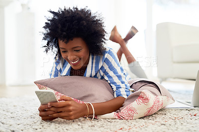 Buy stock photo Woman, home and happy on smartphone with lying on floor for social media post and entertainment. Female person, living room and smile with streaming service or website for funny videos and memes