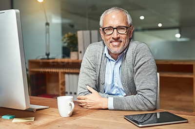 Buy stock photo Portrait of a smiling mature businessman sitting at his desk in an office
