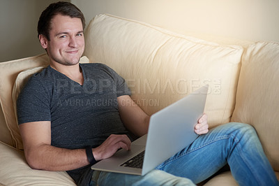 Buy stock photo Man, portrait and smile on sofa with laptop for relax, research and reading in living room of home. Person, computer and happy for communication, networking on internet and streaming on couch
