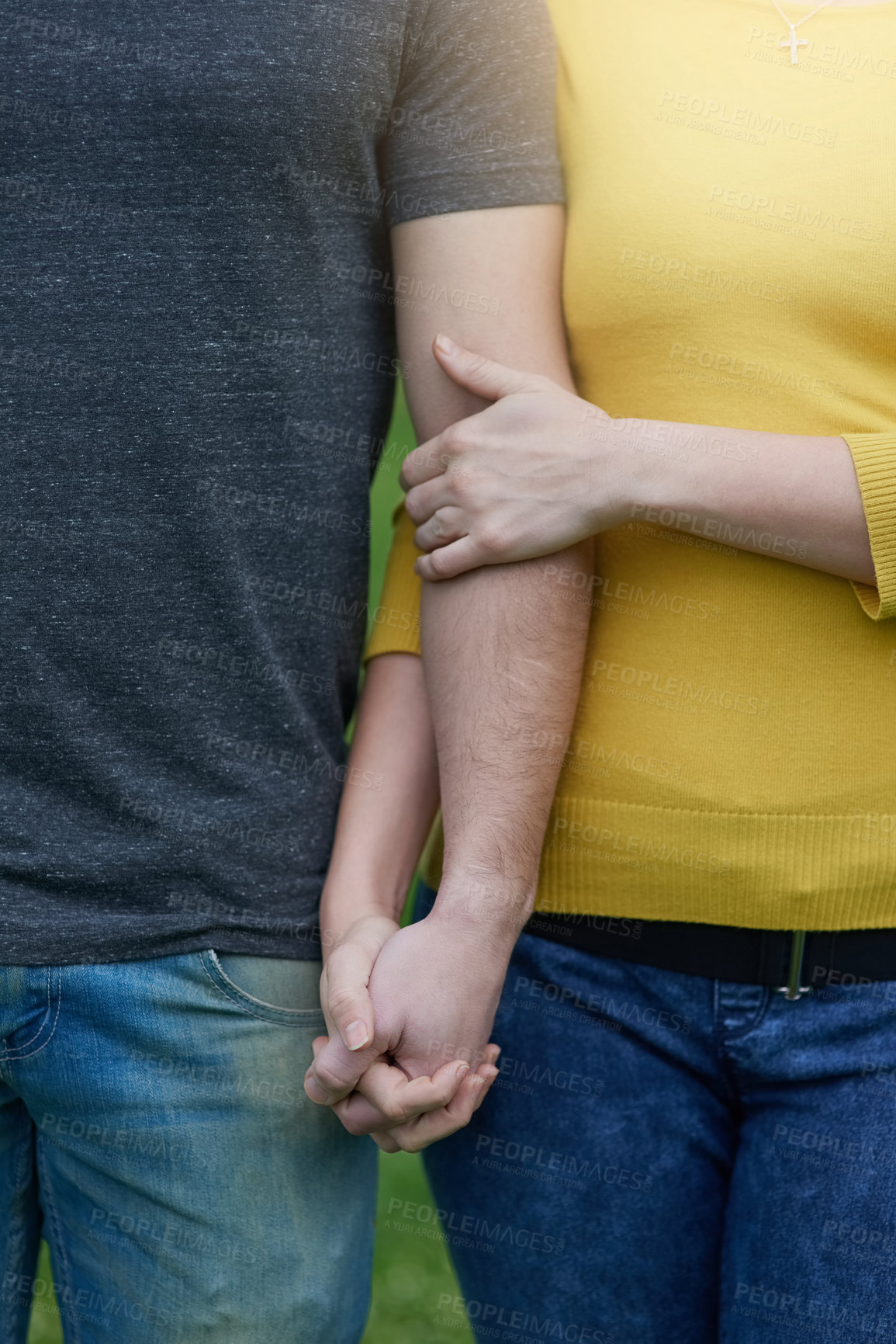 Buy stock photo Shot of an unidentifiable couple holding hands while standing outside together