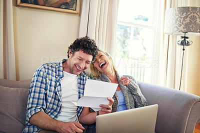 Buy stock photo Laptop, laughing and bills for man, woman and reading in living room, finance and saving in document. Lounge, tax and male person with partner, happiness and technology, online and budget for expense