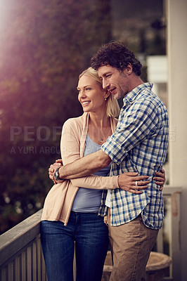 Buy stock photo Shot of a mature couple standing on their balcony at home
