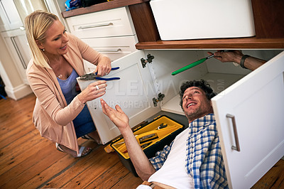 Buy stock photo Lady, help and handyman with tools for fixing home basin, drain or broken interior sewer. Plumber, working and woman watching male person repair for burst pipe, sink leaks and kitchen maintenance