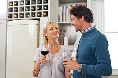 Buy stock photo Couple, alcohol and drinking to celebrate love in home, marriage and relax on anniversary. People, glasses and red wine for milestone in relationship, romance and care in connection or bonding
