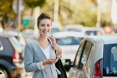 Buy stock photo Portrait of a young businesswoman texting on her cellphone while out in the city