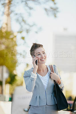 Buy stock photo Cropped shot of a young businesswoman talking on her cellphone while out in the city