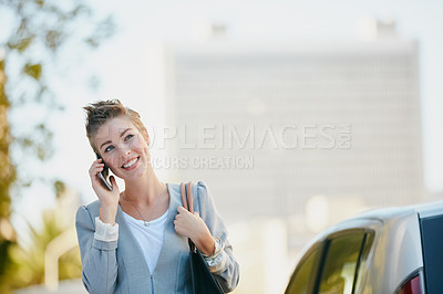 Buy stock photo Cropped shot of a young businesswoman talking on her cellphone while out in the city