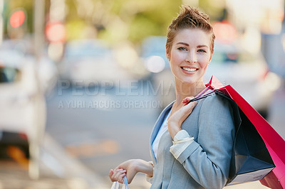 Buy stock photo Portrait of a young businesswoman on a shopping spree in the city