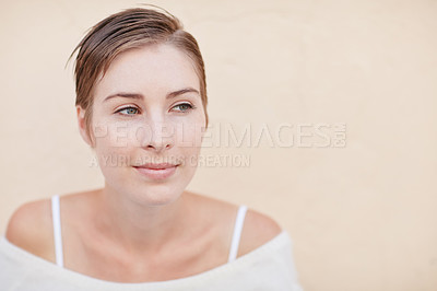 Buy stock photo Shot of a smiling young woman alone at home