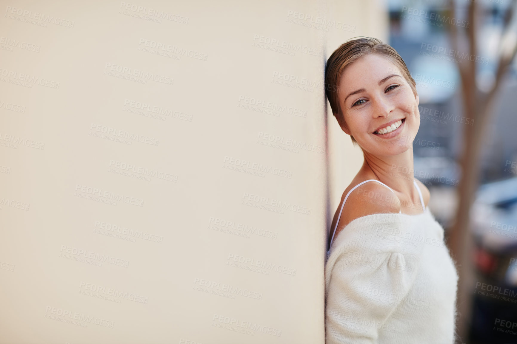 Buy stock photo Portrait of a smiling young woman standing outside