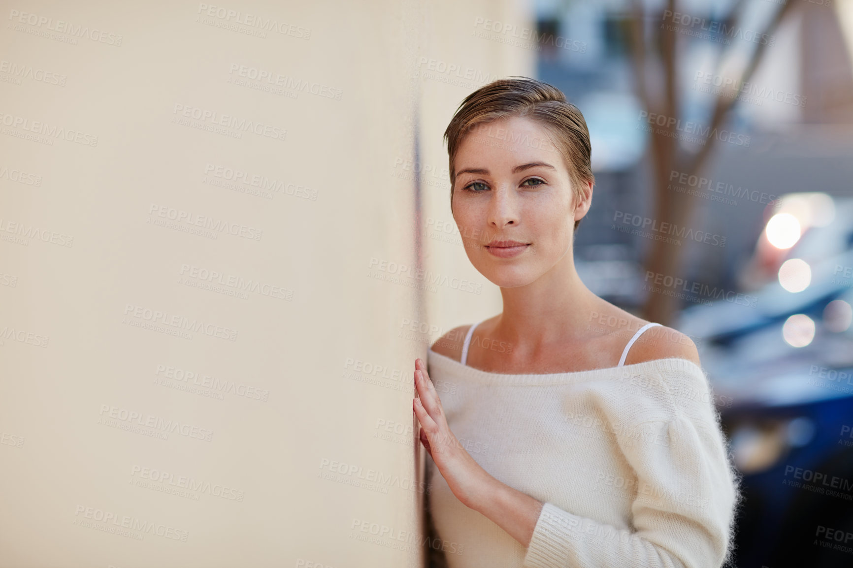 Buy stock photo Portrait of a smiling young woman standing outside