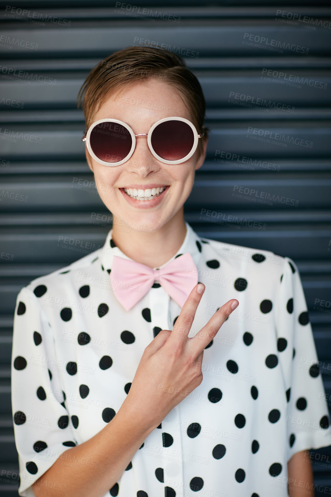 Buy stock photo Portrait of a trendy young woman standing against a corrugated background