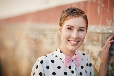 Buy stock photo Portrait of a trendy young woman leaning against a brick wall outside