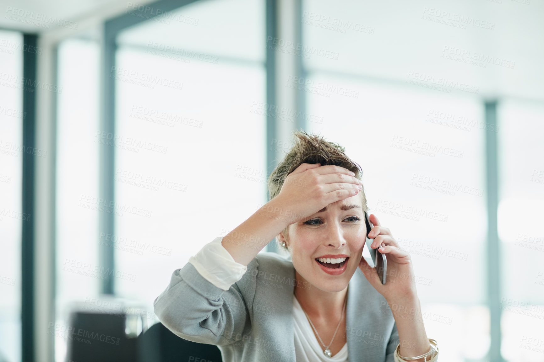 Buy stock photo Cropped shot of a young businesswoman looking anxious while talking on a cellphone in an office