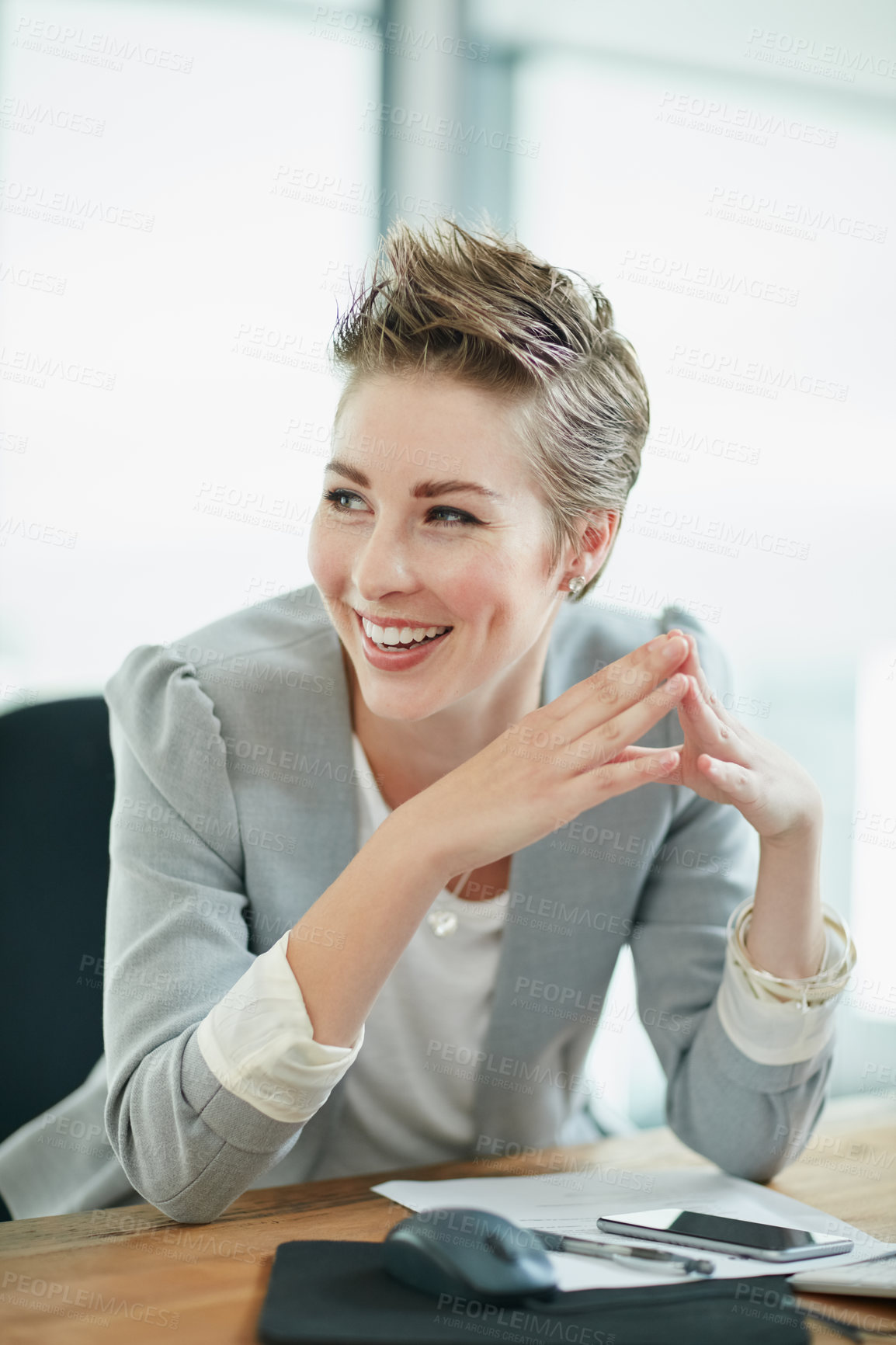 Buy stock photo Cropped shot of a young businesswoman sitting at a desk in an office