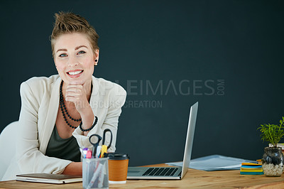 Buy stock photo Portrait of a young businesswoman working on a laptop in an office