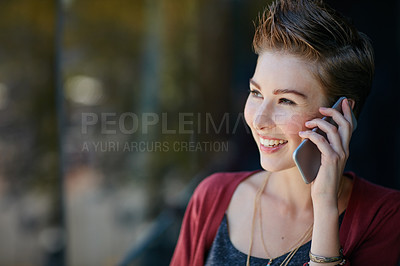 Buy stock photo Shot of an attractive young businesswoman using her cellphone while standing on her office balcony