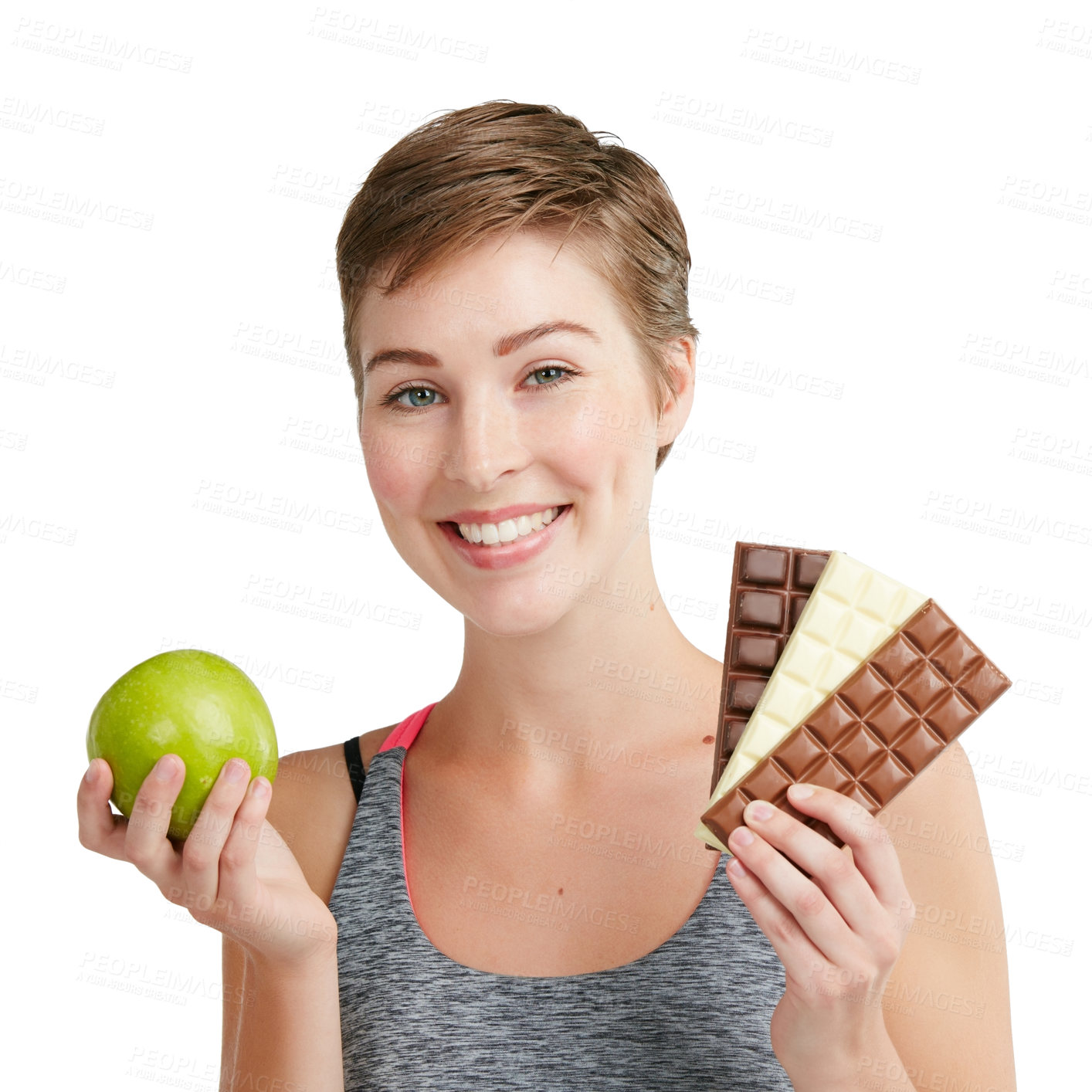 Buy stock photo Studio portrait of a fit young woman deciding whether to eat chocolate or an apple against a white background