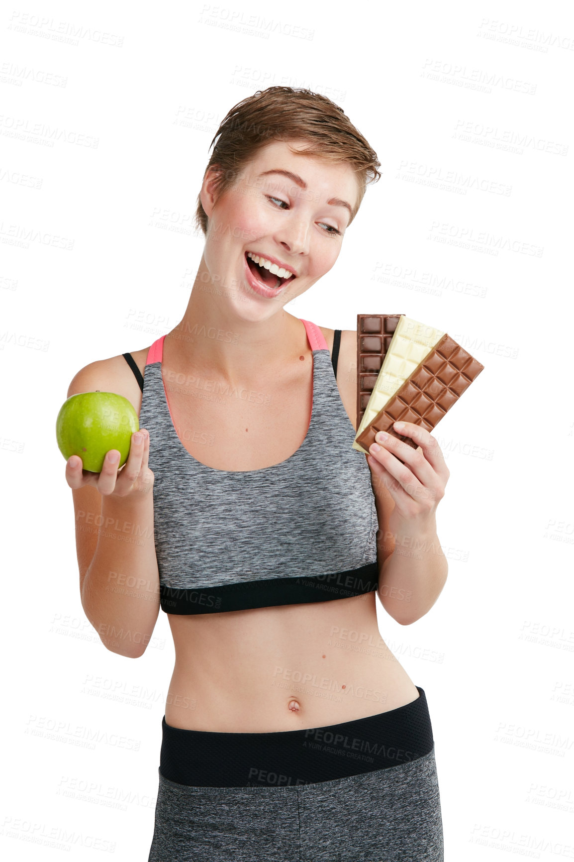 Buy stock photo Studio shot of a fit young woman deciding whether to eat chocolate or an apple against a white background