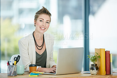 Buy stock photo Portrait of a young businesswoman working on a laptop in an office