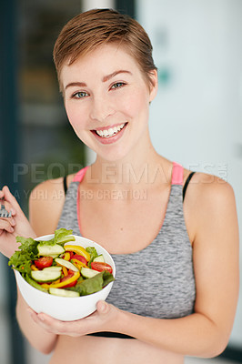 Buy stock photo Portrait of a fit young woman eating a bowl of salad