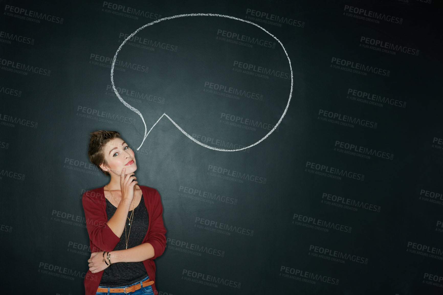 Buy stock photo Studio shot of a young woman posing with a chalk illustration of a speech bubble against a dark background