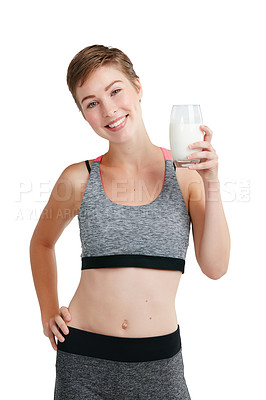 Buy stock photo Studio portrait of a fit young woman holding a glass of milk against a white background