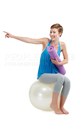 Buy stock photo Pilates, pointing and woman isolated on a white background with balance ball for product placement on mockup. Happy fitness, exercise or workout person or yoga sports portrait show mockup in studio