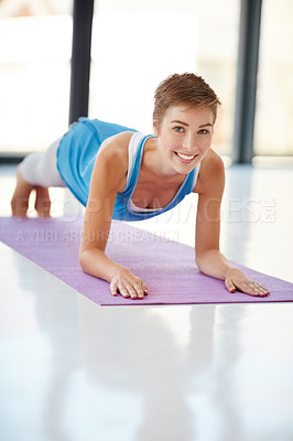 Buy stock photo Woman, portrait smile and plank on yoga mat for healthy fitness, spiritual wellness or zen workout indoors. Happy female yogi in warm stretch smiling in happiness for exercise or pilates at the gym